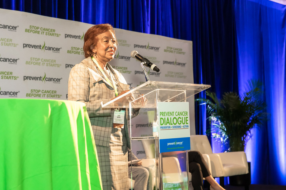 Dr. Edith Mitchell standing at a podium that says Prevent Cancer Dialogue