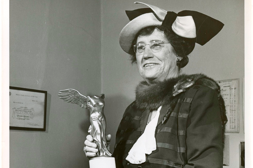 Dr. Elise Depew Strang L’Esperance holding an award