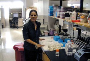 Dr. Anna Giuliano stands in her research lab facing the camera and smiling.