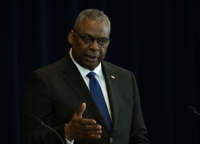 US Defense Secretary Lloyd Austin participates in the US-Philippines 2+2 Ministerial Dialogue Plenary Session on Promoting Regional Security at the State Department in Washington, DC, on April 11, 2023. He is an older Black man wearing glasses and pictured from the waist up with his right arm extended as if he is emphasizing a point.