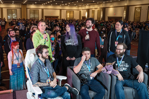 Several gamers and Games Done Quick staff members celebrate on the stage during the event finale.