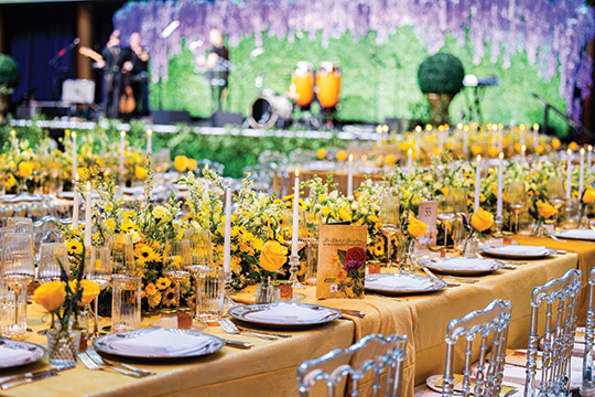 A detail image of table settings at the 2024 Prevent Cancer Annual Gala. The table linens and flowers are golden yellow.