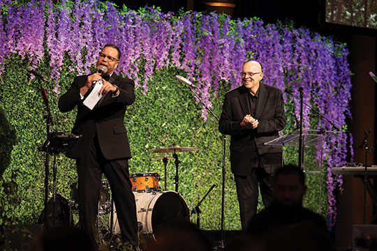 Representative Aaron Bean (Fla.) and Tim Kavanagh on stage at the 2024 Prevent Cancer Annual Gala leading the Lighting the Way auction and live fundraiser.