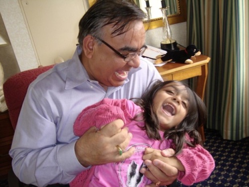 Emily as a little girl with her dad. Both are laughing.