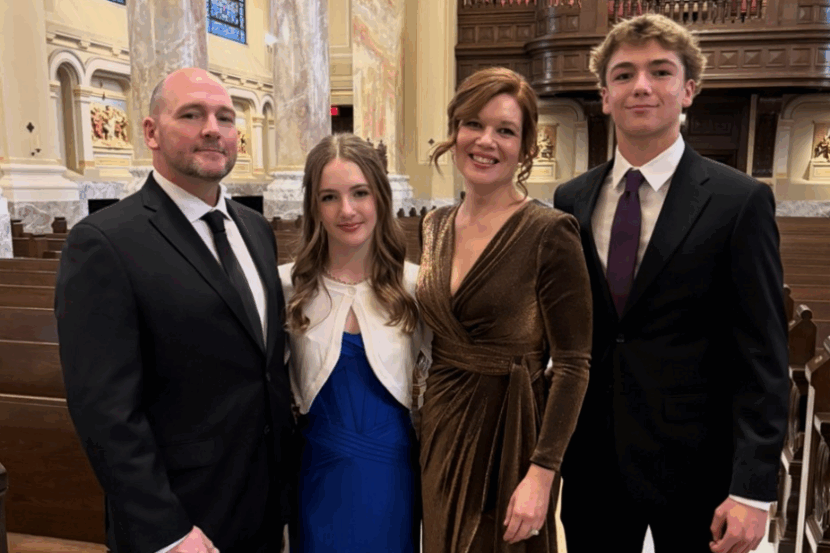MacKenzie with her husband, daughter (age 15) and son (age 17) in a church.