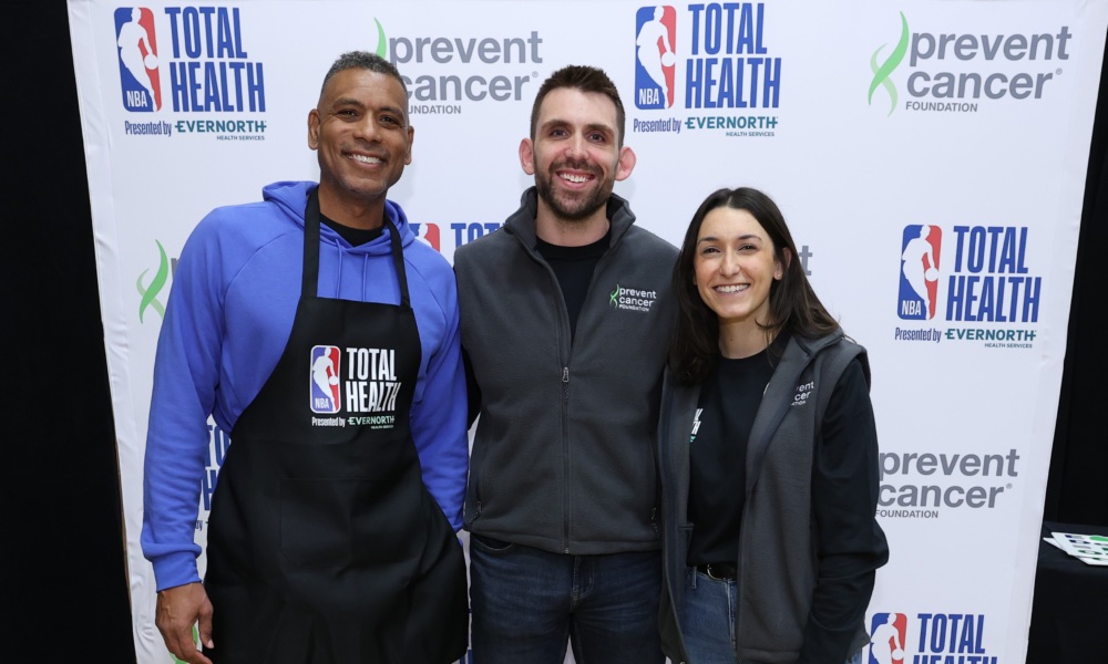 Allan Houston stands with Kyra and Kevin in front of the step and repeat at the NBA total health fair in Las Vegas.