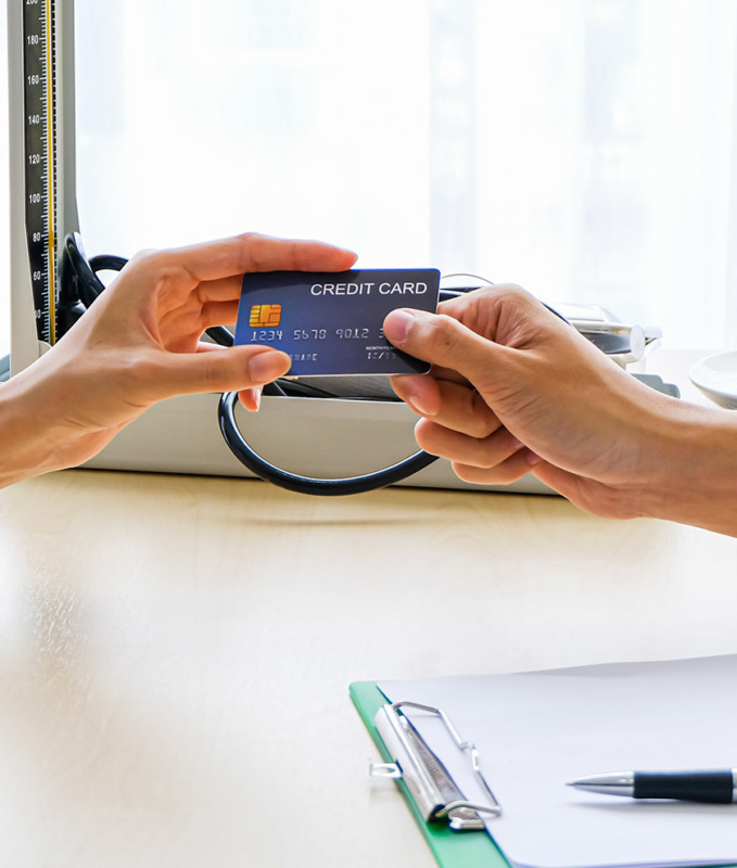 Woman handing over credit card.