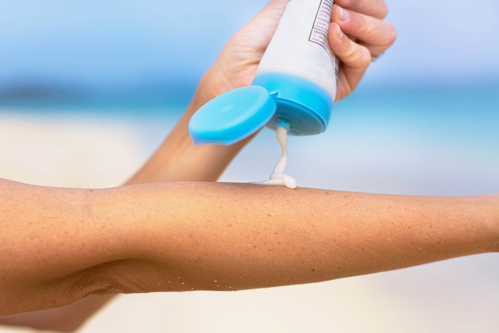 Applying sunblock to arm.