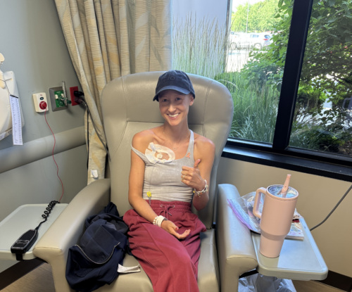 Grace Ganim sitting in a chair during breast cancer treatment.