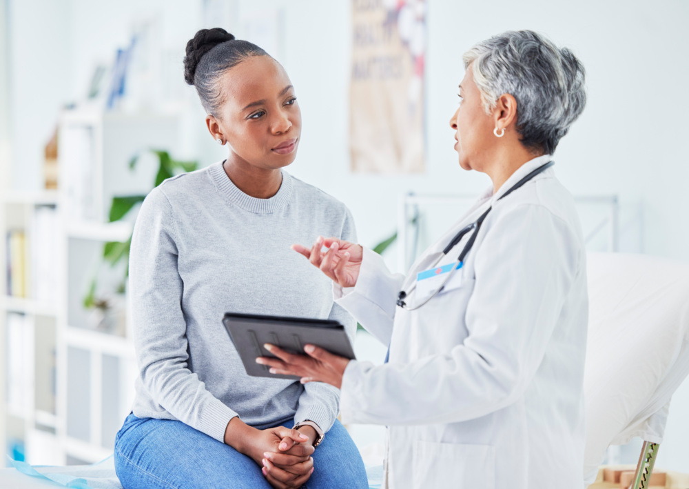 Doctor, woman and tablet for hospital, healthcare advice and support for results, exam and test on bed. Senior expert or medical people on digital tech for clinic sign up, registration and consulting.